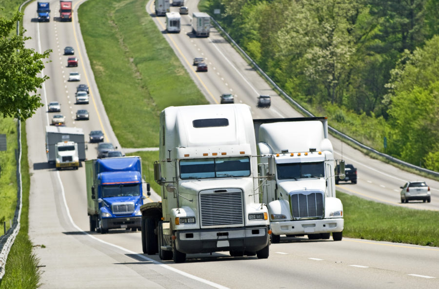 Semi trucks driving down highway