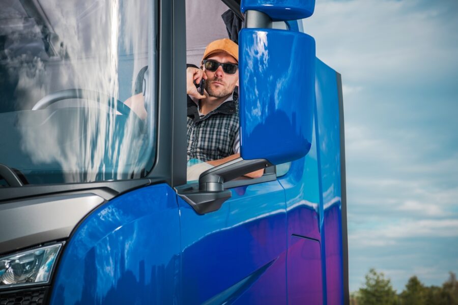 Truck driver on phone leaning out window