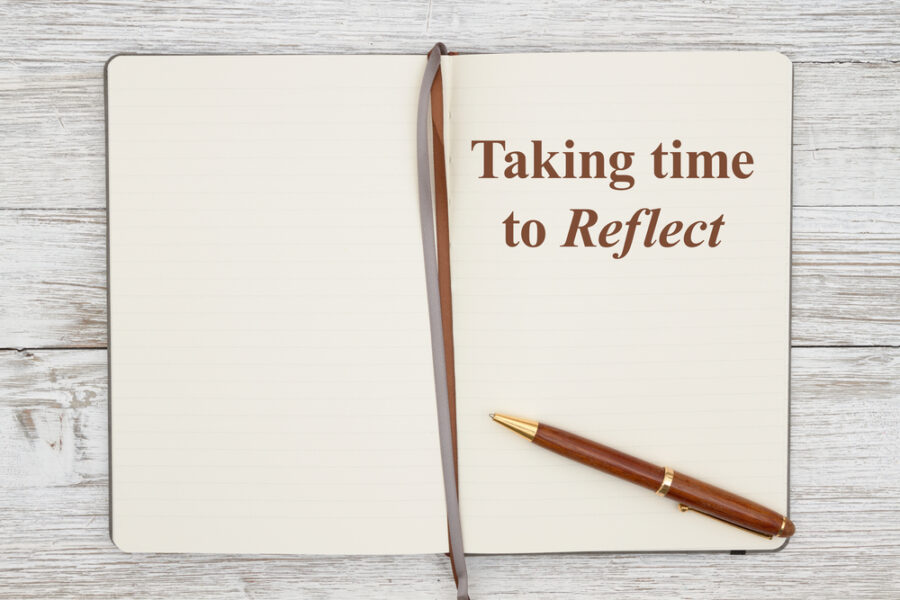 Journal with text "taking time to reflect"