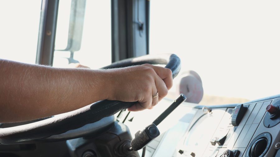 Hands holding a semi-truck steering wheel
