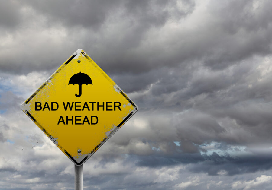 Bad weather ahead road sign with clouds