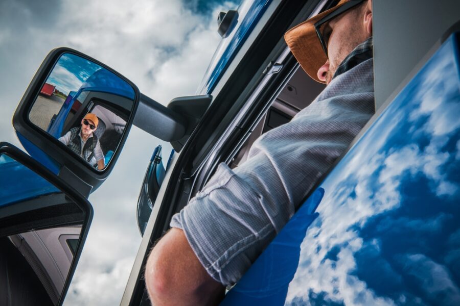 Truck driver looking at side window