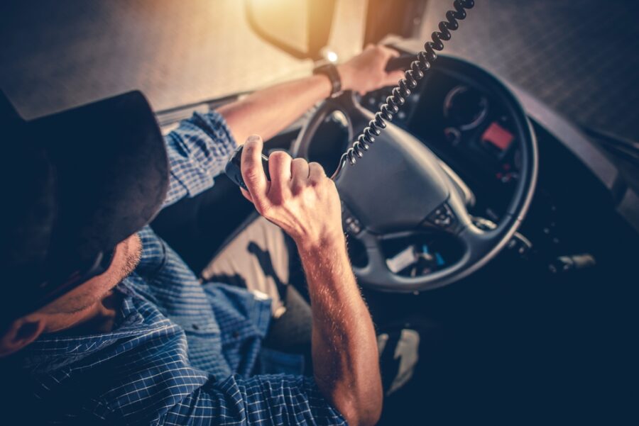 Truck driver talking on two way radio