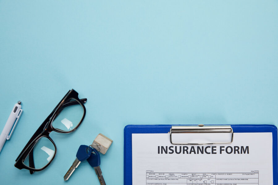 Insurance form on clipboard with blue background