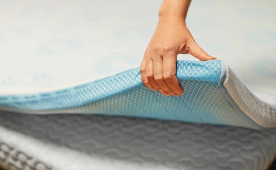 Hand testing a memory foam mattress topper