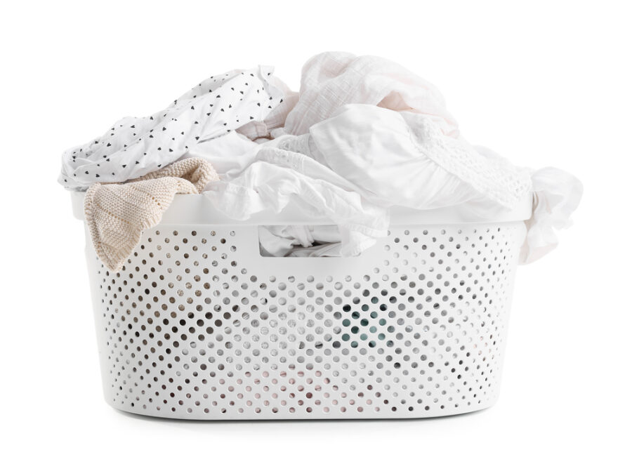 Laundry basket filled with white laundry