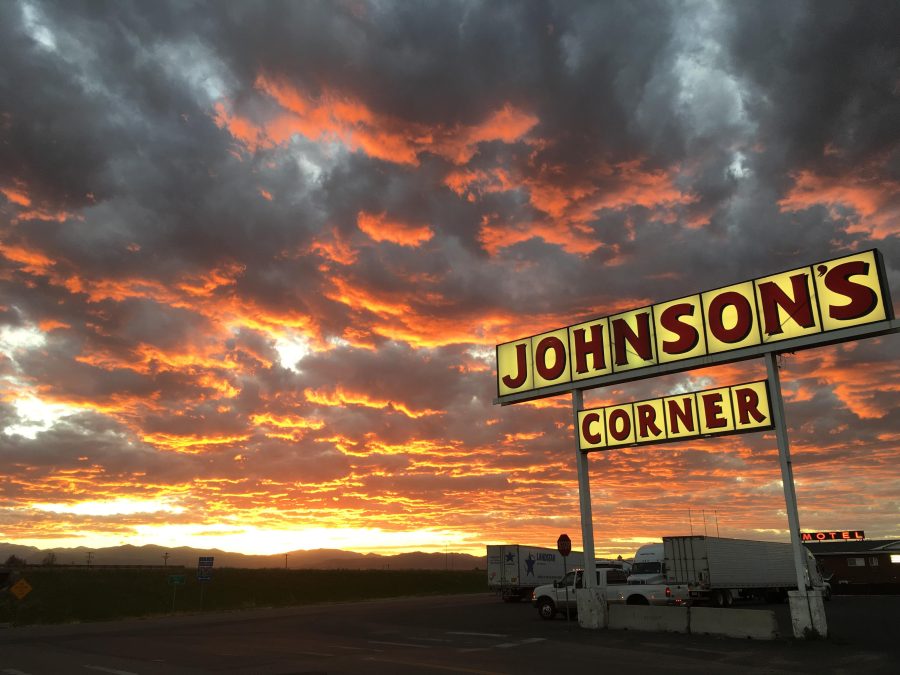 Johnsons corner sign with sunset background