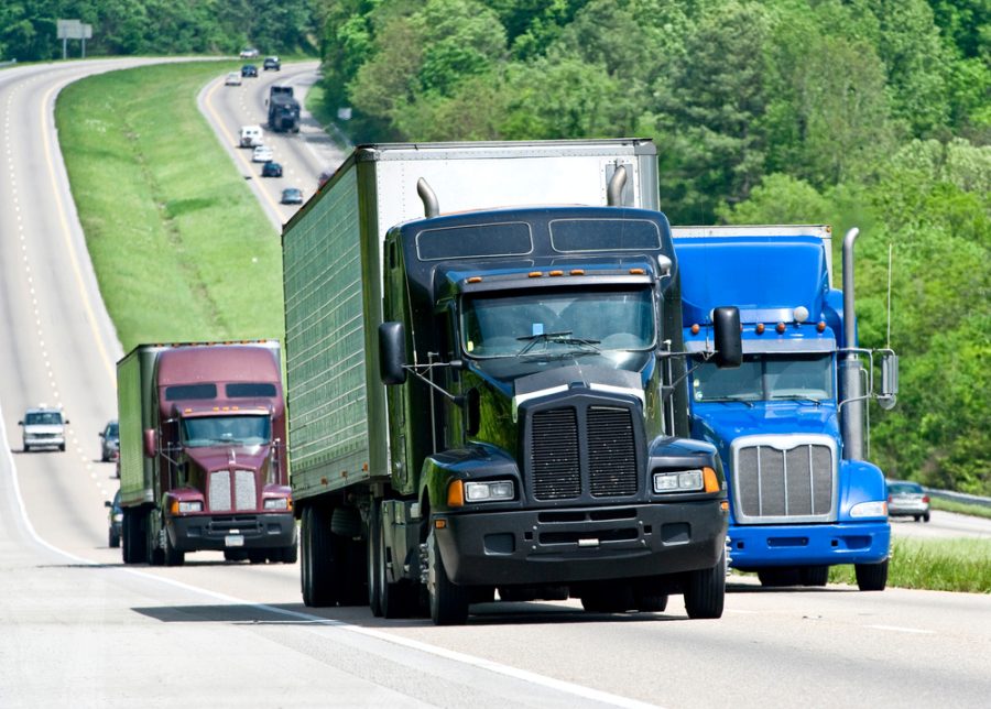 semi trucks driving down highway 