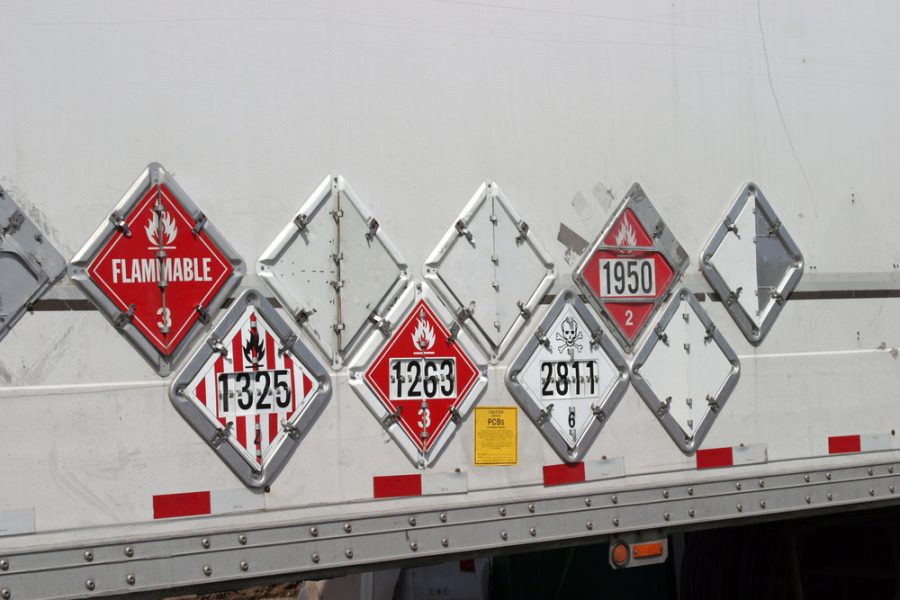 various hazard plackards on the side of a truck.