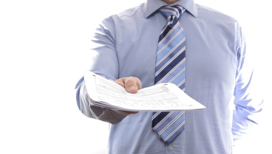 Businessman handing documents. Isolated on white background