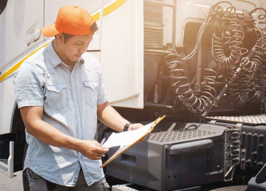 Man inspecting truck