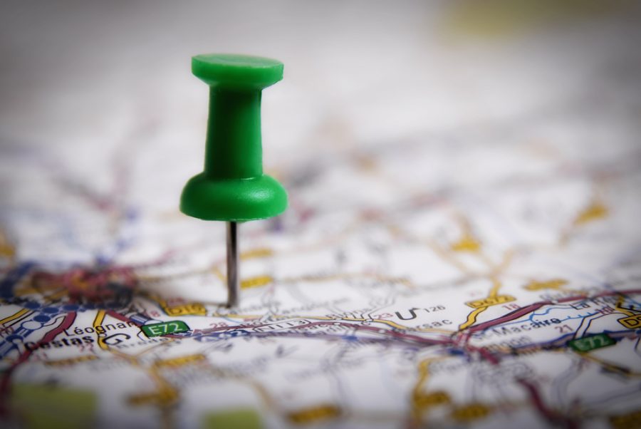 Thumbtack on a map symbol of travel destination