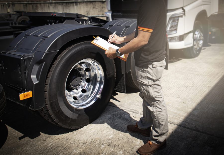 man inspecting semi truckman inspecting semi truck