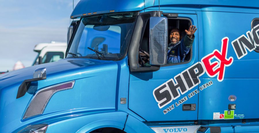 driver waving in blue truck