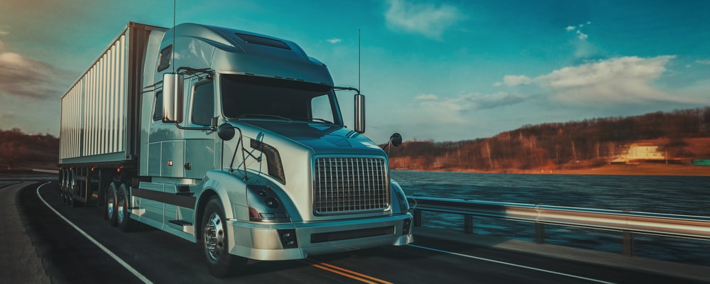 Semi truck driving down road