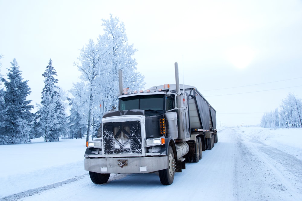 semi truck driving on winter road