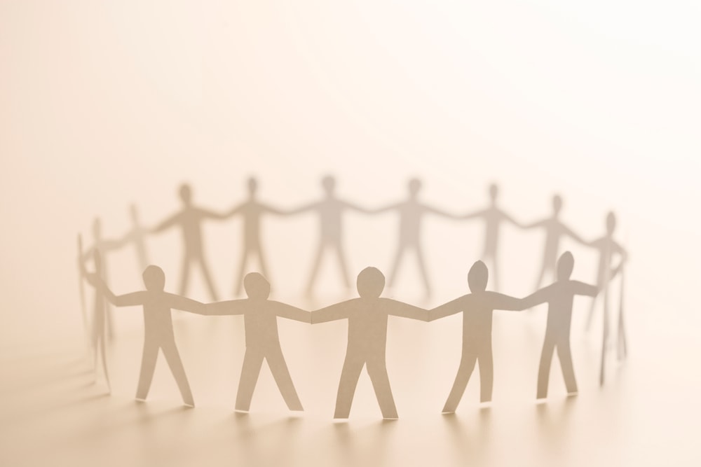 Paper people holding hands in a circle