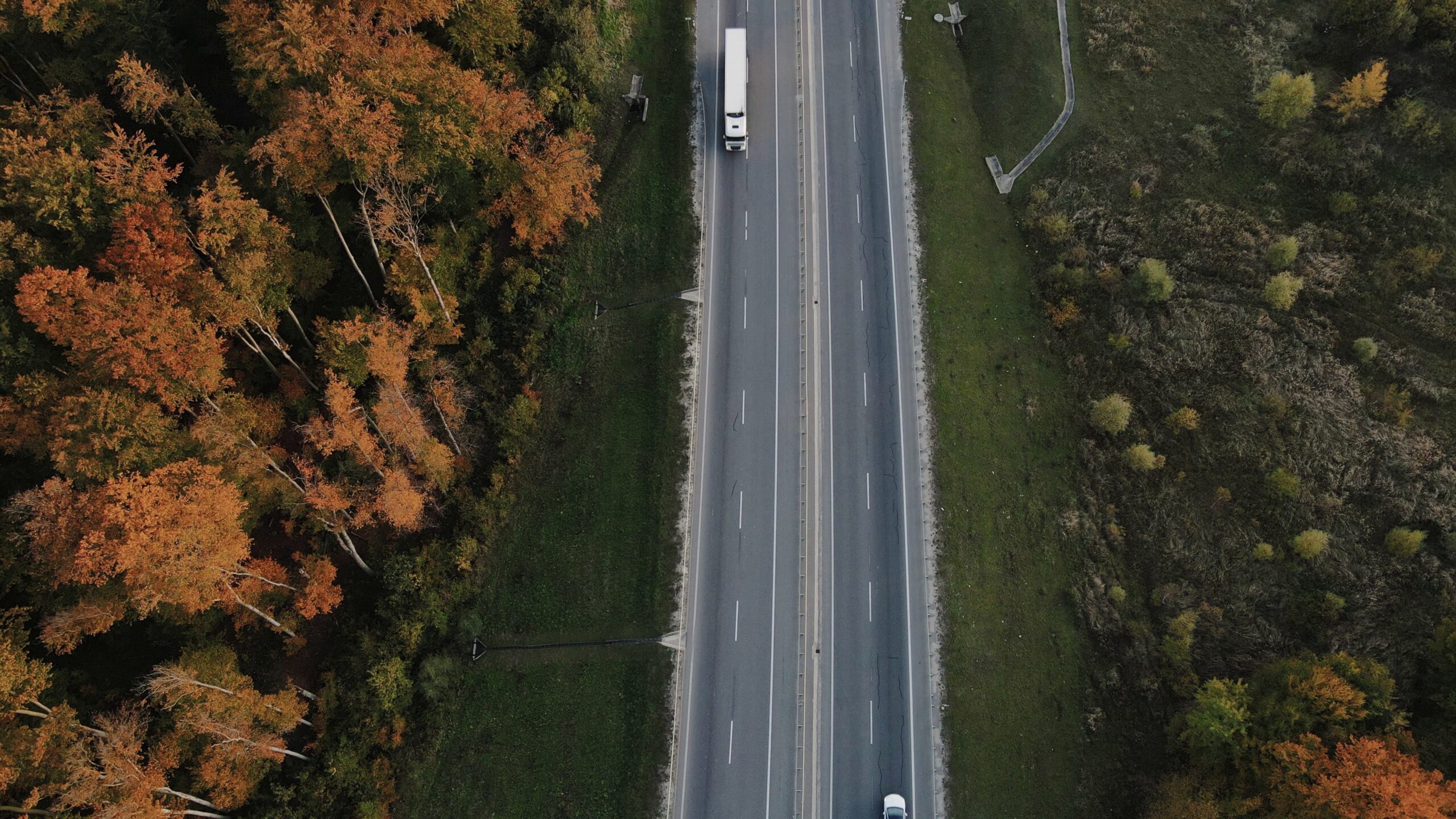 ariel image of a white truck driving on the freeway
