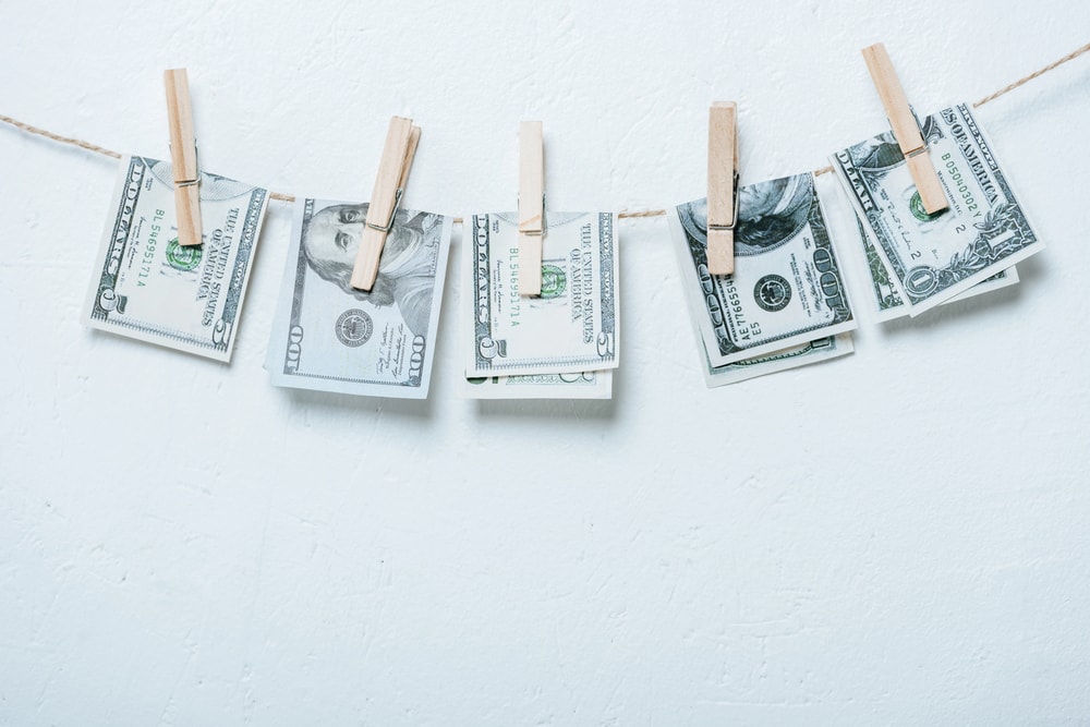 money attached to twine with clothes pin 