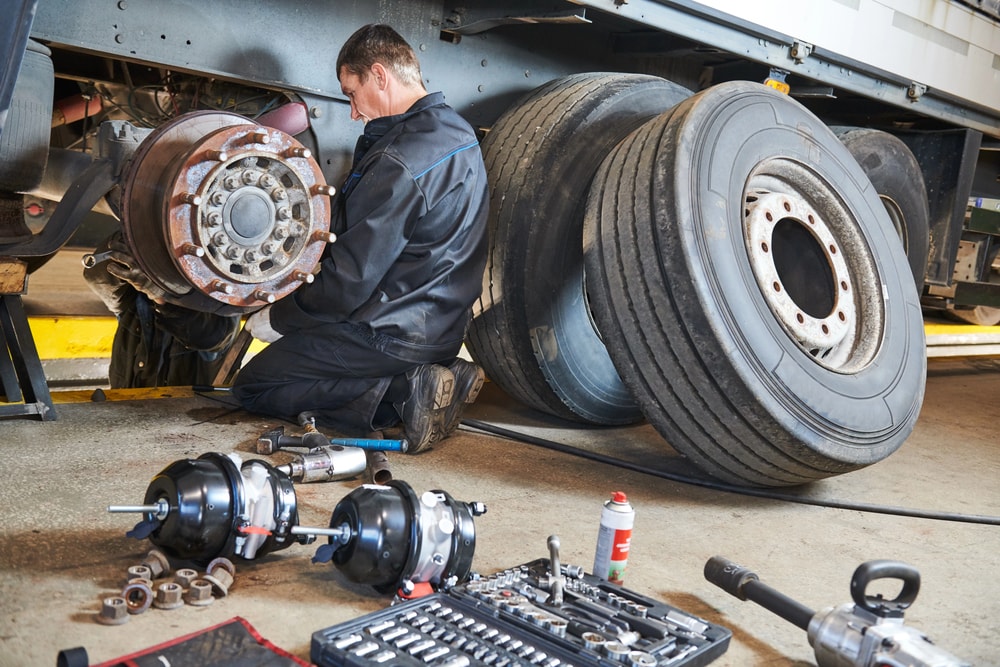 maintenance working on semi truck tires